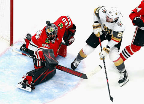 Corey Crawford #50 of the Chicago Blackhawks makes the first period save as William Carrier #28 of the Vegas Golden Knights looks for the rebound in Game Four of the Western Conference First Round.(Photo by Jeff Vinnick/Getty Images)