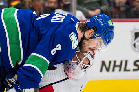 Mar 11, 2022; Vancouver, British Columbia, CAN; Vancouver Canucks forward Conor Garland (8) collides with Washington Capitals goalie Vitek Vanecek (41) in the third period at Rogers Arena. Capitals won 4-3 in overtime. Mandatory Credit: Bob Frid-USA TODAY Sports