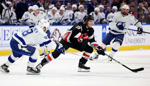 Mar 4, 2023; Buffalo, New York, USA; Buffalo Sabres center Peyton Krebs (19) skates with the puck as Tampa Bay Lightning defenseman Mikhail Sergachev (98) defends during the second period at KeyBank Center. Mandatory Credit: Timothy T. Ludwig-USA TODAY Sports