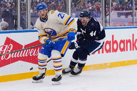 Mar 13, 2022; Hamilton, Ontario, CAN; Buffalo Sabres forward Vinnie Hinostroza (29) skates against Toronto Maple Leafs defenseman Morgan Rielly (44) during the first period in the 2022 Heritage Classic ice hockey game at Tim Hortons Field. Mandatory Credit: John E. Sokolowski-USA TODAY Sports