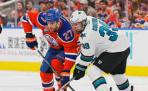 Edmonton Oilers forward Milan Lucic (27) and San Jose Sharks forward Logan Couture (39) battle for a loose puck (Perry Nelson-USA TODAY Sports)