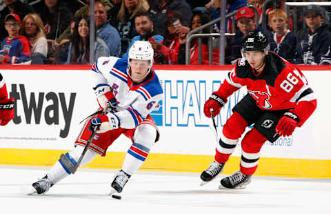 NEWARK, NEW JERSEY – SEPTEMBER 30: Zac Jones #6 of the New York Rangers skates past Jack Hughes #86 of the New Jersey Devils during the first period at the Prudential Center on September 30, 2022, in Newark, New Jersey. (Photo by Bruce Bennett/Getty Images)