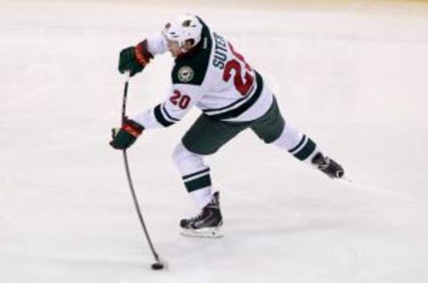 Oct 28, 2013; Saint Paul, MN, USA; Minnesota Wild defenseman Ryan Suter (20) shoots during the second period against the Chicago Blackhawks at Xcel Energy Center. Mandatory Credit: Brace Hemmelgarn-USA TODAY Sports