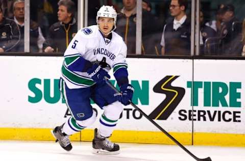 Feb 24, 2015; Boston, MA, USA; Vancouver Canucks defenseman Luca Sbisa (5) carries the puck against the Boston Bruins during the second period at TD Garden. Mandatory Credit: Winslow Townson-USA TODAY Sports