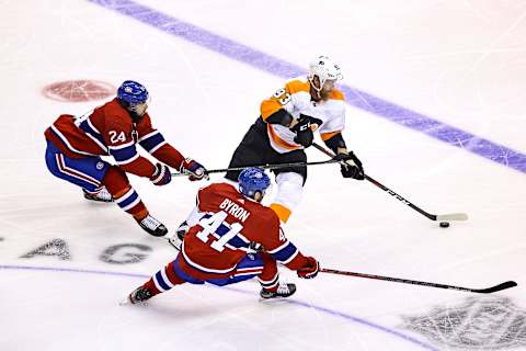 TORONTO, ONTARIO – AUGUST 16: Jakub Voracek #93 of the Philadelphia Flyers is defended by Phillip Danault #24 and Paul Byron #41 of the Montreal Canadiens during the second period in Game Three of the Eastern Conference First Round during the 2020 NHL Stanley Cup Playoffs at Scotiabank Arena on August 16, 2020 in Toronto, Ontario. (Photo by Elsa/Getty Images)