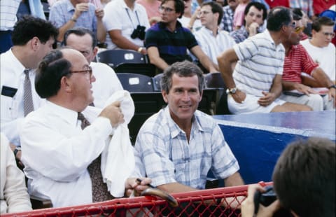 ARLINGTON, TX – JULY 1990: MLB Commissioner Fay Vincent and Texas Rangers managing general partner George W. Bush look on during a July 1990 Texas Rangers game at Arlington Stadium in Arlington, Texas. (Photo by A. Kaye/Getty Images)