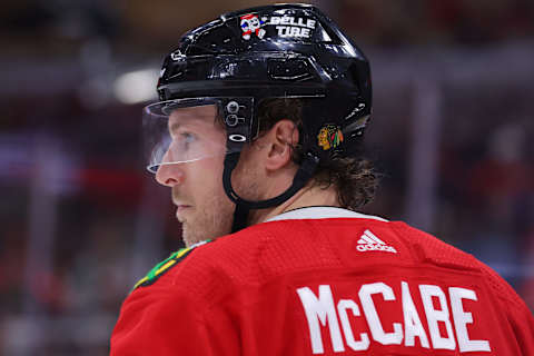 CHICAGO, ILLINOIS – JANUARY 14: Jake McCabe #6 of the Chicago Blackhawks looks on against the Seattle Kraken during the third period at United Center on January 14, 2023 in Chicago, Illinois. (Photo by Michael Reaves/Getty Images)