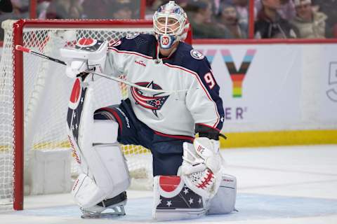 Mar 5, 2023; Ottawa, Ontario, CAN; Columbus Blue Jackets goalie Elvis Merzlikins (90) stretches during a break in the first period against the Ottawa Senators at the Canadian Tire Centre. Mandatory Credit: Marc DesRosiers-USA TODAY Sports