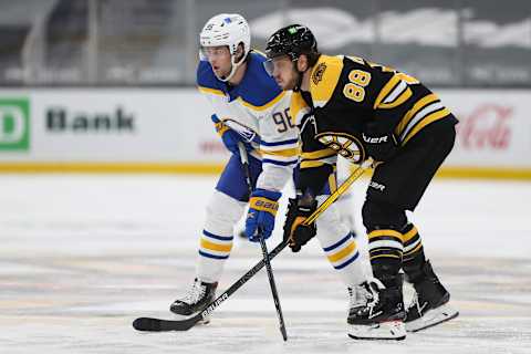 BOSTON, MA – APRIL 13: Anders Bjork #96 of the Buffalo Sabres and David Pastrnak #88 of the Boston Bruins look on in the second period of a game at TD Garden on April 13, 2021 in Boston, Massachusetts. (Photo by Adam Glanzman/Getty Images)