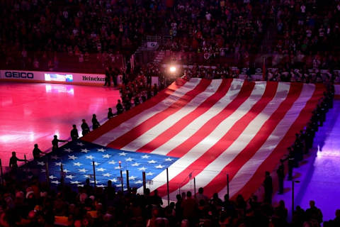 Nov 12, 2016; Glendale, AZ, USA; Members of the US armed forces hold a flag as the Arizona Coyotes and the Boston Bruins look on during the National Anthem, prior to the game at Gila River Arena. Mandatory Credit: Matt Kartozian-USA TODAY Sports