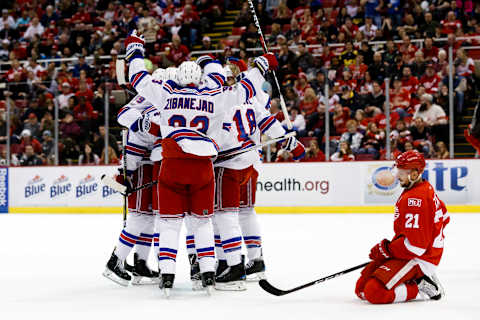 Mar 12, 2017; Detroit, MI, USA; New York Rangers players celebrate a goal by defenseman Ryan McDonagh (27) as Detroit Red Wings left wing Tomas Tatar (21) reacts in the second period at Joe Louis Arena. Mandatory Credit: Rick Osentoski-USA TODAY Sports.