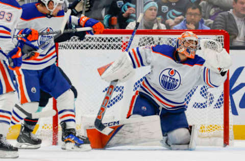 Nov 11, 2023; Seattle, Washington, USA; Edmonton Oilers goaltender Stuart Skinner (74) makes a glove save against the Seattle Kraken during the third period at Climate Pledge Arena. Mandatory Credit: Joe Nicholson-USA TODAY Sports