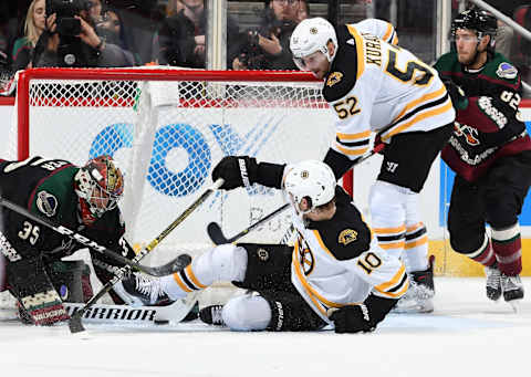 GLENDALE, AZ – NOVEMBER 17: Goalie Darcy Kuemper #35 of the Arizona Coyotes makes a stick save on the shot attempt by Anders Bjork #10 of the Boston Bruins as Sean Kuraly #52 of the Bruins looks to play the puck during the second period at Gila River Arena on November 17, 2018 in Glendale, Arizona. (Photo by Norm Hall/NHLI via Getty Images)