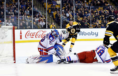 Mar 2, 2017; Boston, MA, USA; New York Rangers goalie Henrik Lundqvist (30) makes a save in front of defenseman Marc Staal (18) during the first period against the Boston Bruins at TD Garden. Mandatory Credit: Bob DeChiara-USA TODAY Sports.