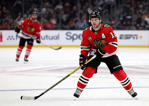 LOS ANGELES, CALIFORNIA – MARCH 24: Alex DeBrincat #12 of the Chicago Blackhawks forechecks during a 4-3 Blackhawks win over the Los Angeles Kings at Crypto.com Arena on March 24, 2022 in Los Angeles, California. (Photo by Harry How/Getty Images)