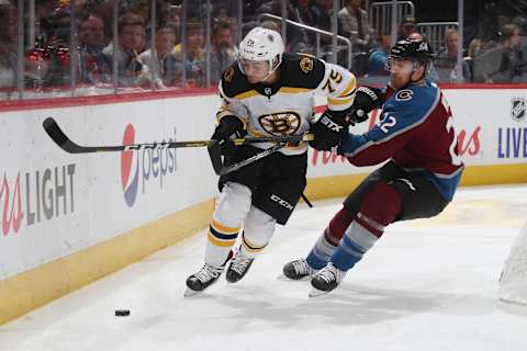 DENVER, COLORADO – OCTOBER 10: Colin Wilson #22 of the Colorado Avalanche skates against Connor Clifton #75 of the Boston Bruins at Pepsi Center on October 10, 2019 in Denver, Colorado. (Photo by Michael Martin/NHLI via Getty Images)