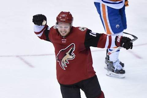 Jan 12, 2016; Glendale, AZ, USA; Arizona Coyotes center Max Domi (16) celebrates after scoring a goal for his first NHL hat trick during the third period against the Edmonton Oilers at Gila River Arena. Mandatory Credit: Matt Kartozian-USA TODAY Sports