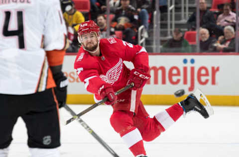 DETROIT, MI – FEBRUARY 13: Mike Green #25 of the Detroit Red Wings shoots the puck past the defense of Adam Henrique #14 of the Anaheim Ducks. (Photo by Dave Reginek/NHLI via Getty Images)