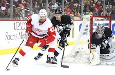 Feb 18, 2016; Pittsburgh, PA, USA; Detroit Red Wings center Darren Helm (43) skates around the net with the puck as Pittsburgh Penguins defenseman Ben Lovejoy (12) and goalie Marc-Andre Fleury (29) defend during the first period at the CONSOL Energy Center. Mandatory Credit: Charles LeClaire-USA TODAY Sports