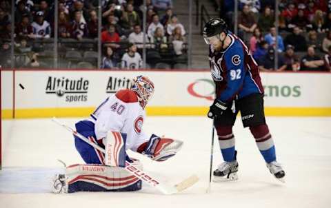 Feb 17, 2016; Denver, CO, USA; Colorado Avalanche left wing Gabriel Landeskog (92) shields a goal by right wing Jarome Iginla (12) (not pictured) past Montreal Canadiens goalie Ben Scrivens (40) in the second period at Pepsi Center. Mandatory Credit: Ron Chenoy-USA TODAY Sports