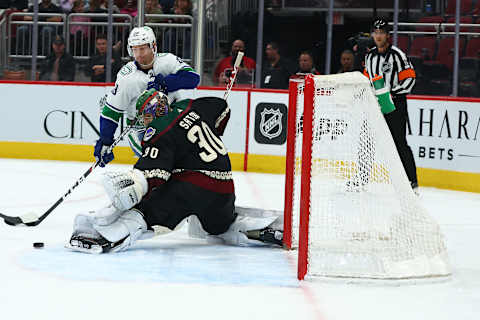 Apr 7, 2022; Glendale, Arizona, USA; Arizona Coyotes goaltender Harri Sateri (30) defends the goal against Vancouver Canucks right wing Alex Chiasson (39) during the third period at Gila River Arena. Mandatory Credit: Mark J. Rebilas-USA TODAY Sports