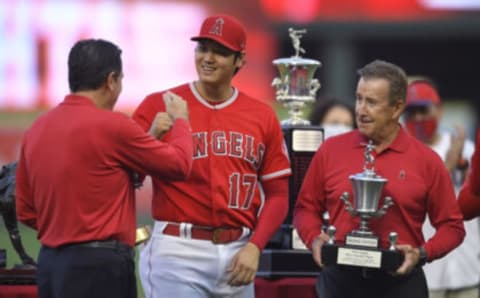 Angels general manager Perry Minasian (left) with Shohei Ohtani and team owner Arte Moreno. (Photo by John McCoy/Getty Images)