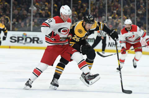 BOSTON, MA – MAY 12: Andrei Svechnikov #37 of the Carolina Hurricane fights for the puck against Brandon Carlo #25 of the Boston Bruins in Game Two of the Eastern Conference Final during the 2019 NHL Stanley Cup Playoffs at the TD Garden on May 12, 2019 in Boston, Massachusetts. (Photo by Steve Babineau/NHLI via Getty Images)