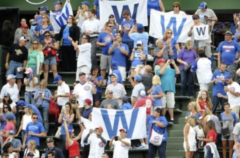 Sep 23, 2016; Chicago, IL, USA; Fans in the bleachers celebrate the Chicago Cubs win against the St. Louis Cardinals at Wrigley Field. The Cubs won 5-0. Mandatory Credit: David Banks-USA TODAY Sports