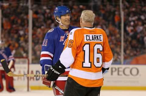 PHILADELPHIA, PA – DECEMBER 31: Bobby Clarke #16 of the Philadelphia Flyers and Mark Messier #11 of the New York Rangers talk during the 2012 Bridgestone NHL Winter Classic Alumni Game on December 31, 2011 at Citizens Bank Park in Philadelphia, Pennsylvania. (Photo by Jim McIsaac/Getty Images)