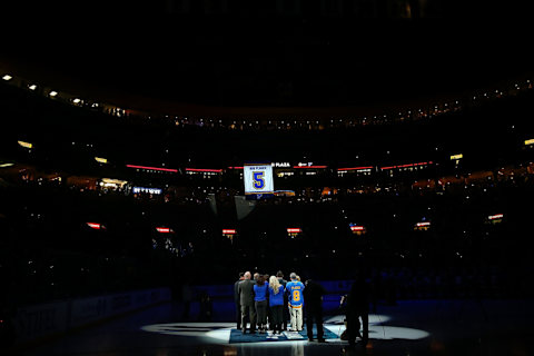 Family members of former St. Louis Blues player Bob Plager watch as his number is raised to the rafter. (Photo by Dilip Vishwanat/ Getty Images)