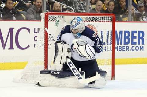 Feb 16, 2017; Pittsburgh, PA, USA; Winnipeg Jets goalie Connor Hellebuyck (37) makes a save against the Pittsburgh Penguins during the second period at the PPG PAINTS Arena. The Penguins won 4-3 in overtime. Mandatory Credit: Charles LeClaire-USA TODAY Sports