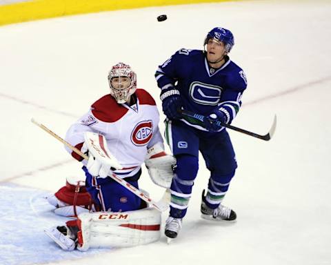 Oct 30, 2014; Vancouver, British Columbia, CAN; Vancouver Canucks player Alexandre Burrows (14) and Montreal Canadiens goaltender Carey Price (31) watch the puck during the third period at Rogers Arena. The Vancouver Canucks won in overtime 3-2. Mandatory Credit: Anne-Marie Sorvin-USA TODAY Sports