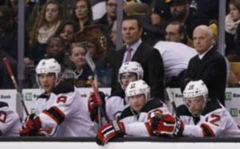 Jan 8, 2015; Boston, MA, USA; New Jersey Devils co-coach Adam Oates (left) and general manager Lou Lamoriello (right) on the bench during the third period against the Boston Bruins at TD Banknorth Garden. The Boston Bruins won 3-0. Mandatory Credit: Greg M. Cooper-USA TODAY Sports