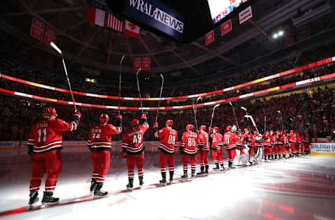 RALEIGH, NC – OCTOBER 3: Teammates of the Carolina Hurricanes salute the fans during pregame introductions prior to an NHL game against the Montreal Canadiens on October 3, 2019 at PNC Arena in Raleigh North Carolina. (Photo by Gregg Forwerck/NHLI via Getty Images)