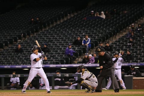 DENVER, CO – APRIL 26: Gerardo Parra #8 of the Colorado Rockies takes an at bat in front of empty stands as catcher Francisco Cervelli #29 of the Pittsburgh Pirates backs up the plate and umpire Dale Scott oversees the action at Coors Field on April 26, 2016 in Denver, Colorado. The Pirates defeated Rockies 9-4. (Photo by Doug Pensinger/Getty Images)