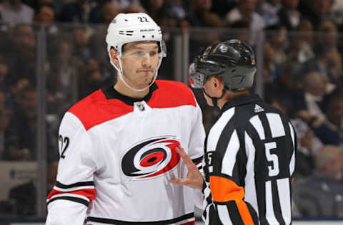 TORONTO, ON – DECEMBER 19: Referee Chris Rooney #5 explains to Brett Pesce #22 of the Carolina Hurricanes to be careful, or he will draw a penalty against the Toronto Maple Leafs in an NHL game at the Air Canada Centre on December 19, 2017, in Toronto, Ontario, Canada. The Maple Leafs defeated the Hurricanes 8-1. (Photo by Claus Andersen/Getty Images)