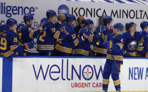 Jan 14, 2021; Buffalo, New York, USA; Buffalo Sabres left wing Taylor Hall (4) celebrates his goal with teammates during the first period against the Washington Capitals at KeyBank Center. Mandatory Credit: Timothy T. Ludwig-USA TODAY Sports