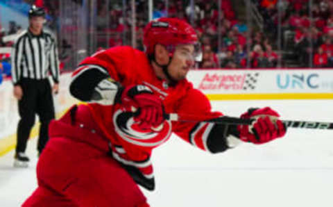 Nov 7, 2023; Raleigh, North Carolina, USA; Carolina Hurricanes defenseman Dmitry Orlov (7) takes a shot against the Buffalo Sabres during the first period at PNC Arena. Mandatory Credit: James Guillory-USA TODAY Sports