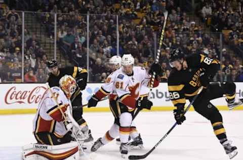 Nov 25, 2016; Boston, MA, USA; Calgary Flames goalie Chad Johnson (31) makes a save in front of defenseman Brett Kulak (61) and Boston Bruins right wing David Pastrnak (88) during the third period at TD Garden. Mandatory Credit: Bob DeChiara-USA TODAY Sports