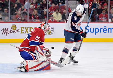 Mar 25, 2023; Montreal, Quebec, CAN; Montreal Canadiens goalie Sam Montembeault (35) blocks a shot as Columbus Blue Jackets forward Lane Pederson (18) screens during the third period at the Bell Centre. Mandatory Credit: Eric Bolte-USA TODAY Sports