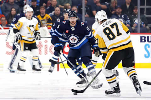 Winnipeg Jets, David Gustafsson (19); Pittsburgh Penguins, Sidney Crosby (87). Mandatory Credit: James Carey Lauder-USA TODAY Sports