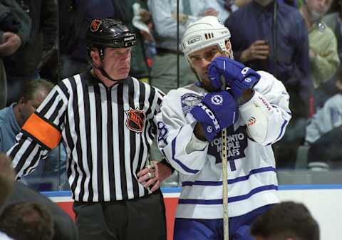 Referee Terry Gregson has a chat with Tie Domi #28 of the Toronto Maple Leafs against the New Jersey Devils during NHL game action on March 3, 1999 at Air Canada Centre in Toronto, Ontario, Canada. (Photo by Graig Abel/Getty Images)