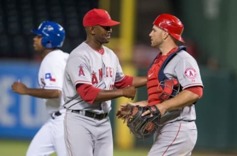 Sep 10, 2014; Arlington, TX, USA; Los Angeles Angels relief pitcher Yoslan Herrera (60) and catcher Chris Iannetta (17) celebrate the win over the Texas Rangers at Globe Life Park in Arlington. The Angels defeated the Rangers 8-1. Mandatory Credit: Jerome Miron-USA TODAY Sports