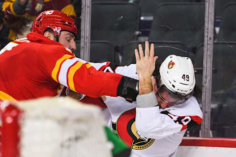 CALGARY, AB – JANUARY 13: Milan Lucic #17 of the Calgary Flames lands a punch that drops Scott Sabourin #49 of the Ottawa Senators during an NHL game at Scotiabank Saddledome on January 13, 2022 in Calgary, Alberta, Canada. (Photo by Derek Leung/Getty Images)