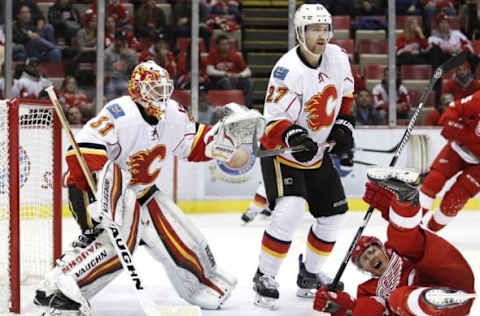 Nov 20, 2016; Detroit, MI, USA; Calgary Flames goalie Chad Johnson (31) and defenseman Dougie Hamilton (27) defend their net against Detroit Red Wings right wing Gustav Nyquist (14) during the third period at Joe Louis Arena. Flames won 3-2. Mandatory Credit: Raj Mehta-USA TODAY Sports