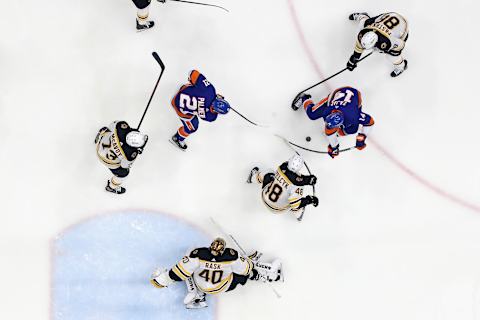 The Boston Bruins defend against the New York Islanders. (Photo by Bruce Bennett/Getty Images)