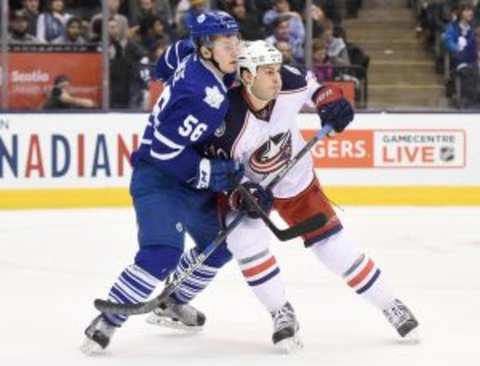 Jan 13, 2016; Toronto, Ontario, CAN; Columbus Blue Jackets right wing Jared Boll (40) battles for position with Toronto Maple Leafs center Byron Froese (56) during the second period at Air Canada Centre. Mandatory Credit: Dan Hamilton-USA TODAY Sports