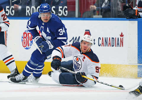 TORONTO, ON – MARCH 29: Connor McDavid #97 of the Edmonton Oilers battles for the puck against Auston Matthews #34 of the Toronto Maple Leafs  . (Photo by Claus Andersen/Getty Images)