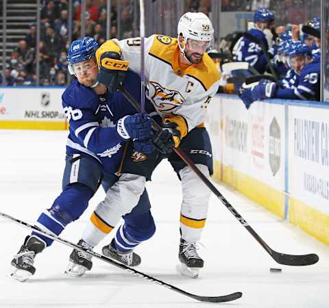 William Nylander #88 of the Toronto Maple Leafs tries to knock Roman Josi #59 of the Nashville Predators off the puck during an NHL game at Scotiabank Arena on November 16, 2021 in Toronto, Ontario, Canada. (Photo by Claus Andersen/Getty Images)