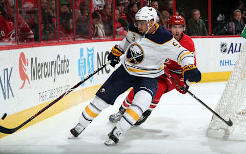 RALEIGH, NC – DECEMBER 23: Jaccob Slavin #74 of the Carolina Hurricanes pursues Evander Kane #9 of the Buffalo Sabres during an NHL game on December 23, 2017 at PNC Arena in Raleigh, North Carolina. (Photo by Gregg Forwerck/NHLI via Getty Images)